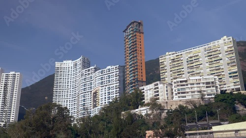Urban landscape with tall buildings at the Hong kong coastline by the beach