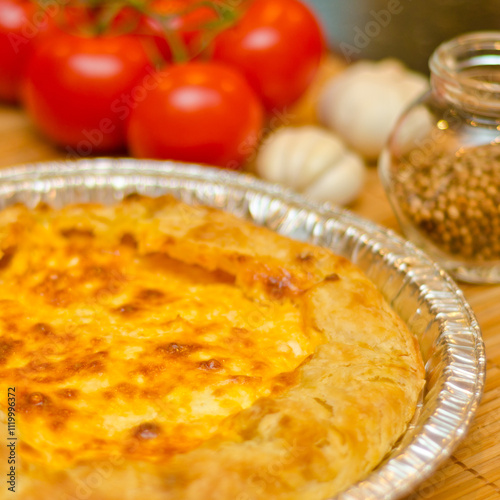 Delicious quiche with tomato, garlick and green.