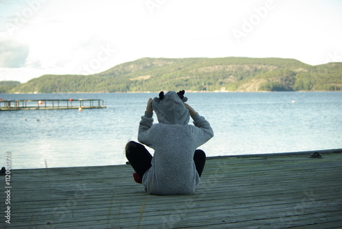 The child with reindeer hoodie looking in the distance.