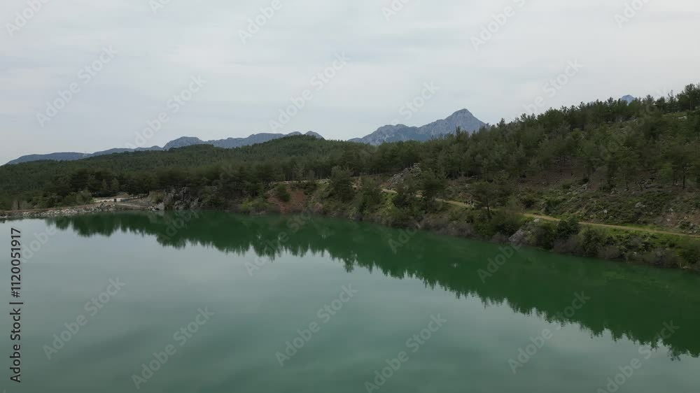 Serene lake surrounded by mountains in a peaceful landscape setting