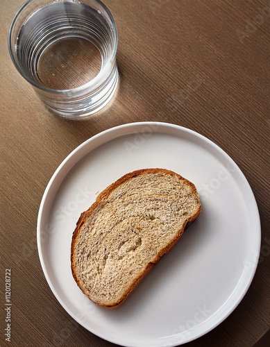 A slice on the plate with a glass of water Topic Poverty, old age poverty or a Dlät