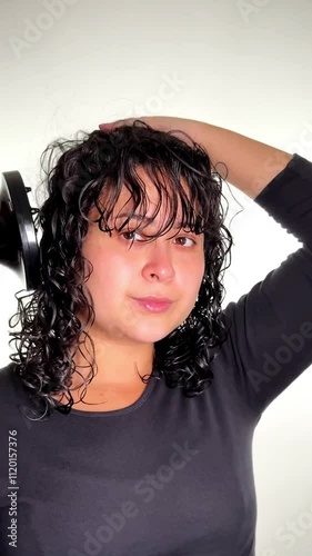 Woman Drying Hair with a Hairdryer photo