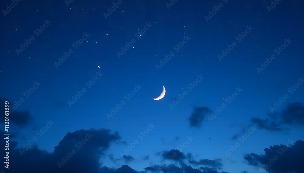 Crescent moon shines brightly in a starlit sky with soft clouds at twilight Crescent moon shines brightly in a starlit sky with soft clouds at twilight