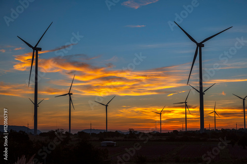 wind turbines at sunset. wind turbine in the sky. wind turbine against sky photo