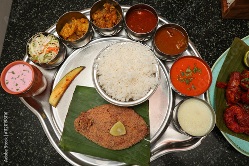 Goa Goan Fish Thali rice served with rawa fried seer fish, Sol Kadi Solkadhi Kokum curry Top View. Indian Fish Platter thali Popular sea food Non vegetarian meal Mumbai Konkan Maharashtra prawns 65