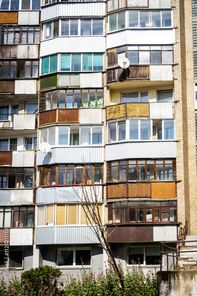 Soviet era architecture style of living district in Vilnius, Lithuania. Post-soviet urban architecture. Wall with windows and balconies. Soviet era architecture style of living district in Vilnius, Lithuania. Post-soviet urban architecture. Wall with windows and balconies.