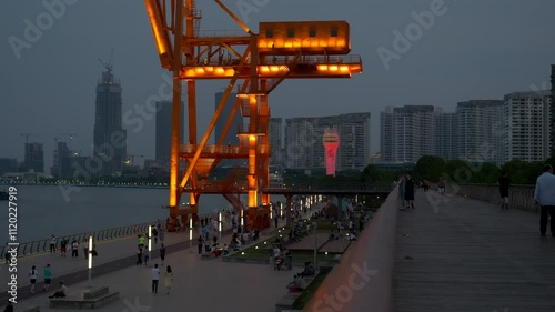 People Walk along Huangpu River in Shanghai by Lit Steel Structure, Night, 4k