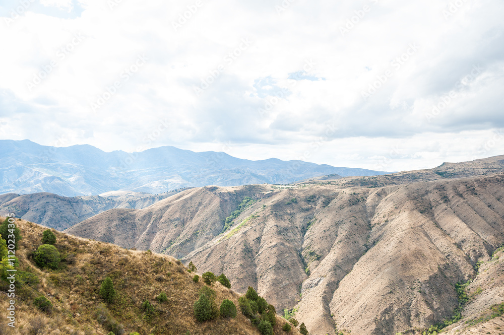 Majestic mountains under a blue sky filled with clouds, showcasing natural beauty and rugged terrain Majestic mountains under a blue sky filled with clouds, showcasing natural beauty and rugged terrain