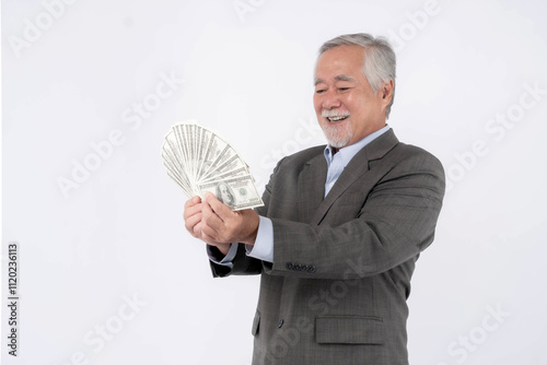 Senior Businessman Smiling While Holding and Fanning a Stack of Cash, Representing Financial Success, Wealth Management, and Prosperity for Older Adults isolated on white background photo