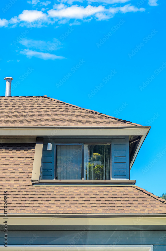 Top of grey stucco luxury house with shingle roof, red and yellow trees and nice windows in Summer in Vancouver, Canada, North America. Day time on June 2024. Top of grey stucco luxury house with shingle roof, red and yellow trees and nice windows in Summer in Vancouver, Canada, North America. Day time on June 2024.