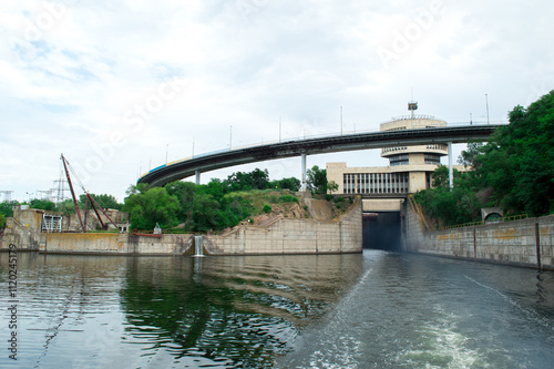 A scenic view of a hydroelectric dam with a modern bridge and lush greenery, showcasing the blend of engineering and nature photo