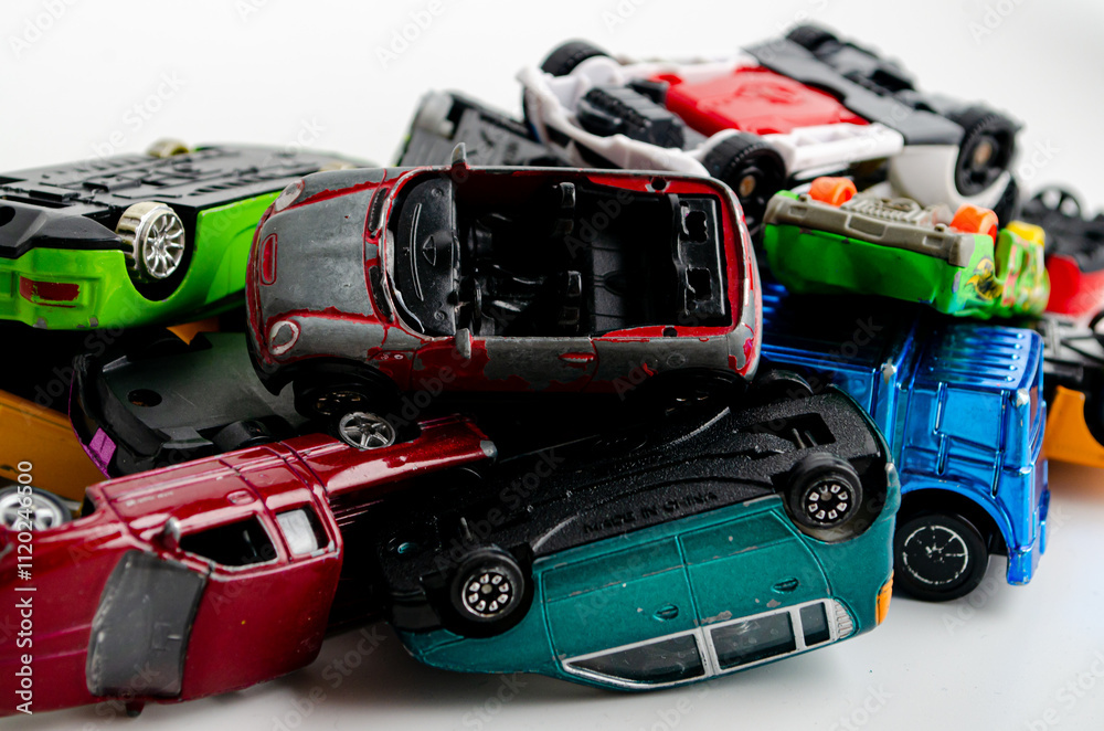 a group of small toy cars piled up in a heap a group of small toy cars piled up in a heap