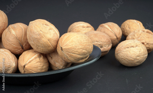 Fresh Quality walnut in black plate and background