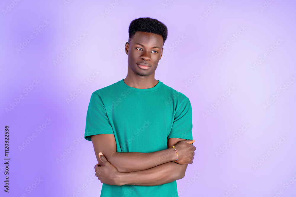 Young man crossing arms, looking away and thinking on purple background Young man crossing arms, looking away and thinking on purple background