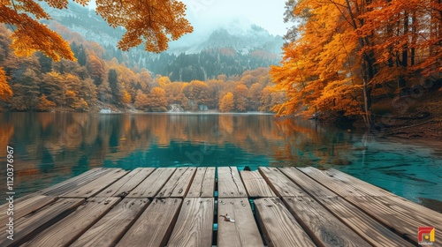 Serene autumn lake scene with wooden dock, vibrant foliage reflecting on calm water, misty mountains in background.