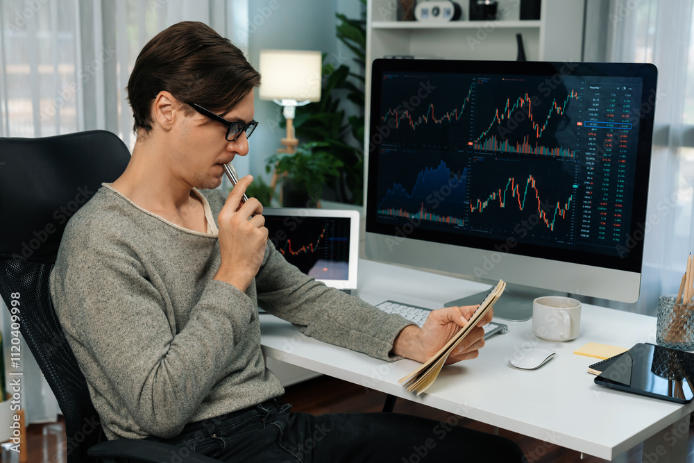 Smart businessman trader in casual day analyzing with profit value of dynamic increased stock exchange market graph, taking note on paper for profitable investment list at modern office. Pecuniary. Smart businessman trader in casual day analyzing with profit value of dynamic increased stock exchange market graph, taking note on paper for profitable investment list at modern office. Pecuniary.