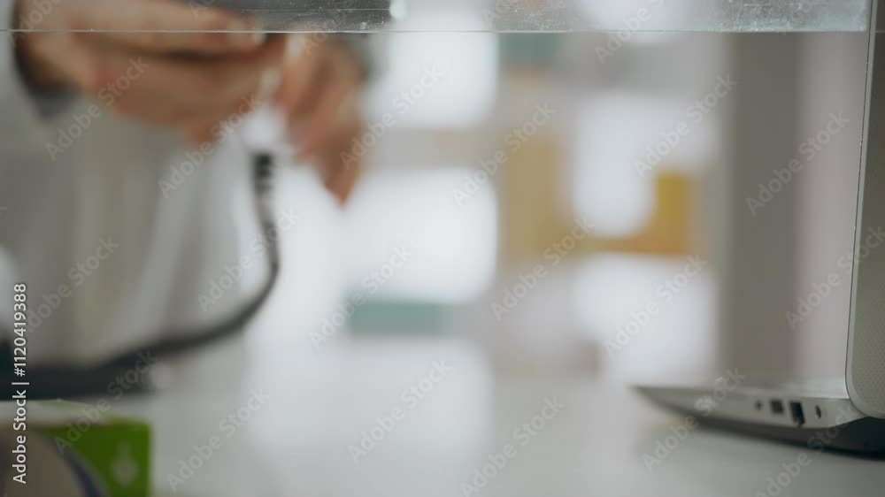 A pharmacist working as a salesperson behind the counter holds out a payment terminal for cashless payments. A buyer of medicines pays for the purchase with a smart watch. Contactless payment A pharmacist working as a salesperson behind the counter holds out a payment terminal for cashless payments. A buyer of medicines pays for the purchase with a smart watch. Contactless payment