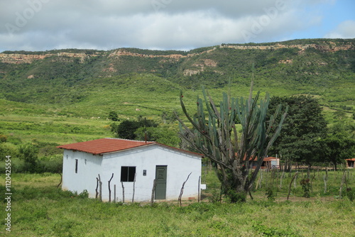 casa com chapada do araripe ao fundo, em exu, pernambuco photo