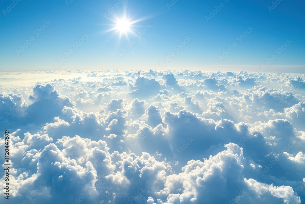 Fototapeta premium Expansive view of sunlit fluffy clouds above the horizon under a clear sky