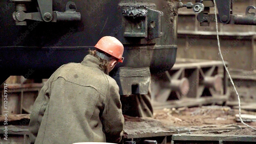 An industrial worker is engaged in important tasks at a busy manufacturing facility. Stock Clip An industrial worker is engaged in important tasks at a busy manufacturing facility. Stock Clip
