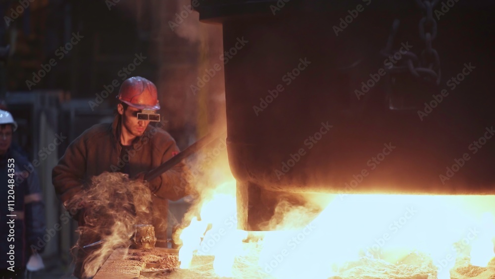 Fototapeta premium Foundries enhance efficiency and safety in molten metal processing through skilled techniques. Stock Clip