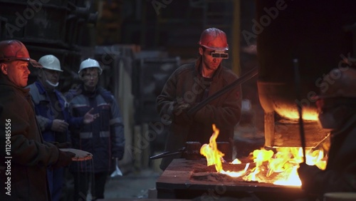 Workers engaged in Steel Production A detailed glimpse into the intricate Foundry Process. Stock Clip