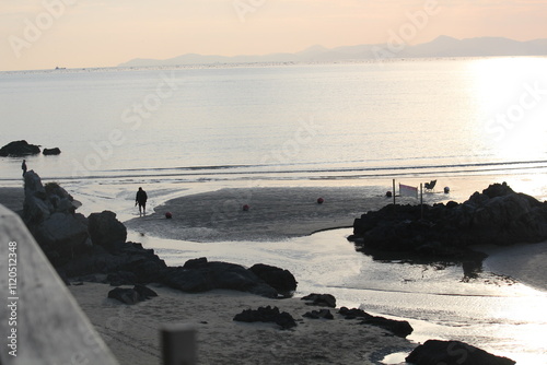 Image of people walking barefoot at Dadaepo Beach in Busan
 photo