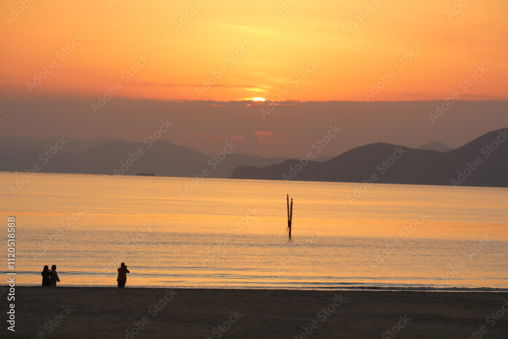 Image of people enjoying a beautiful sunset at Dadaepo Beach in Busan and a landscape image of sunset at sea
Image of people enjoying a beautiful sunset at Dadaepo Beach in Busan and a landscape image of sunset at sea