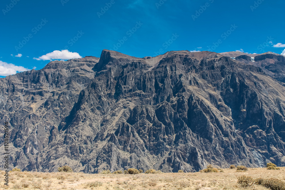 Fototapeta premium Colca canyon in Peru. Rock formations and green terraces in the Andes mountains. Peruvian tourist sights destination near Arequipa
