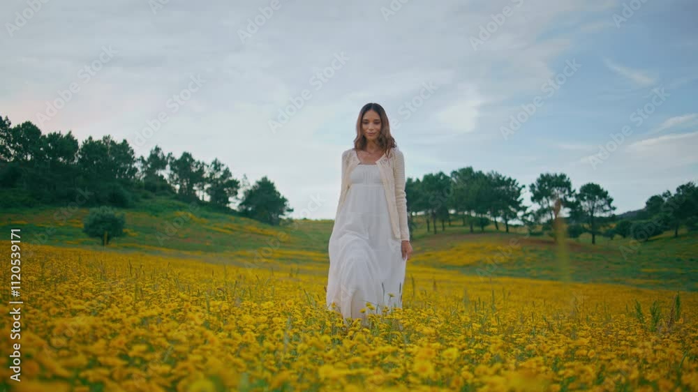 Gentle woman standing flowers field cloudy summer. Lady strolling yellow meadow Gentle woman standing flowers field cloudy summer. Lady strolling yellow meadow