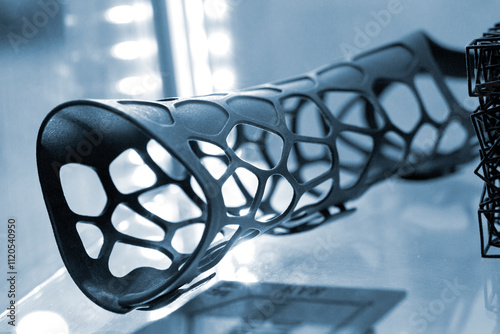 Hand splint corset prosthesis printed on 3D printer from molten black plastic powder. Medical orthosis fixator plastic overlay created on 3D printer. New modern medical 3D printing technologies