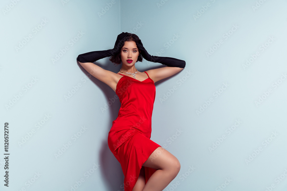 Photo of asian lady touch head posing wear red dress isolated grey studio background