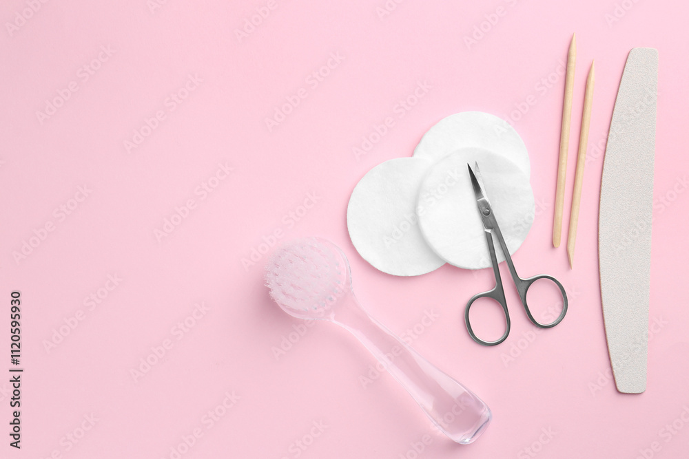 Set of pedicure tools on pink background, flat lay. Space for text Set of pedicure tools on pink background, flat lay. Space for text