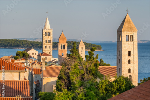 Fototapeta Naklejka Na Ścianę i Meble -  HIstoric towers of a Rab town on Rab island at sunrise, Croatia.