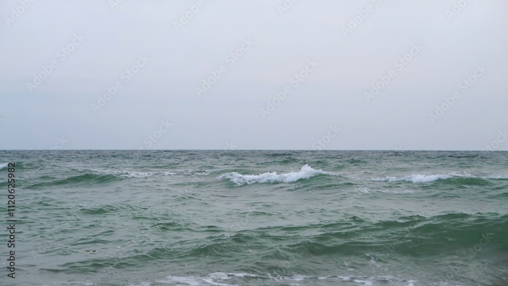 A Tranquil and Calm Seascape Scene Beneath Overcast and Cloudy Skies and Horizons A Tranquil and Calm Seascape Scene Beneath Overcast and Cloudy Skies and Horizons