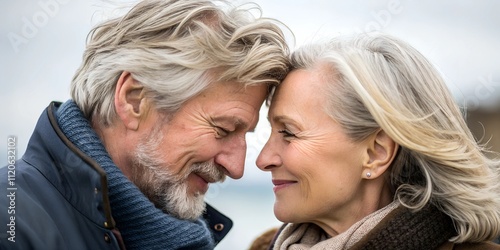 Close up of a mature beautiful Scandinavian couple consisting of an older Nordic Caucasian man and an older European Scandinavian woman who are in love. The shot shows details of their faces	