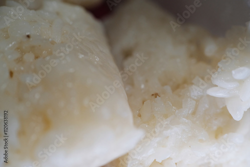 Tapai Pulut Daun Getah is a traditional Malaysian dessert of fermented glutinous rice wrapped in the leaf of a rubber tree photo