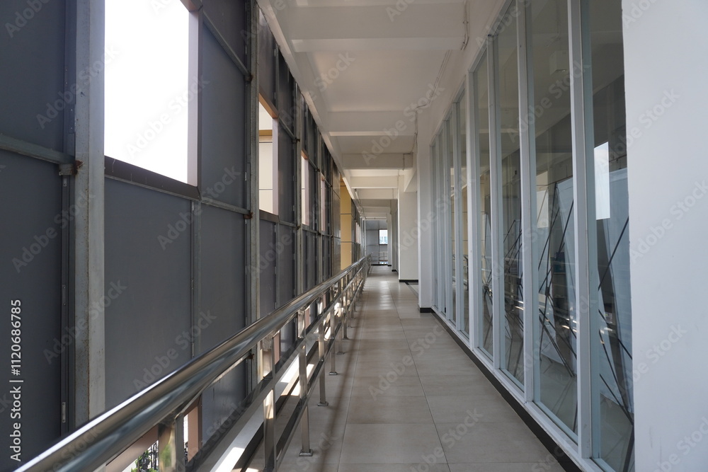 A small hallway in a building between rooms with balconies and holes for lighting. A small hallway in a building between rooms with balconies and holes for lighting.