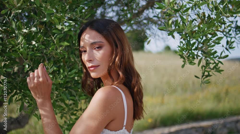 Radiant woman smiling camera in green garden nature closeup. Sensual lady posing