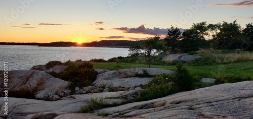 Sunset on the horizon as seen from Coolidge reservation in Manchester by the sea in Massachusetts, USA