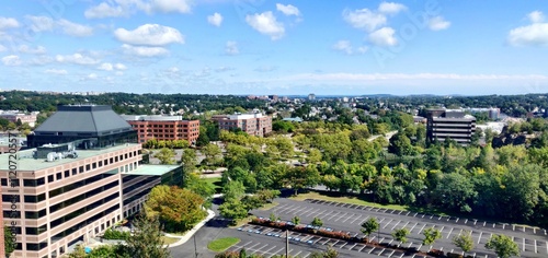 Aerial View of Urban Landscape with Buildings and Trees Under Blue Sky