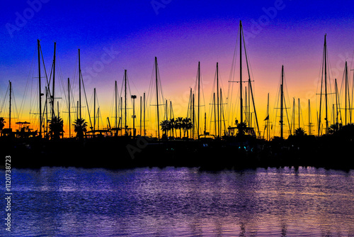 Rockport, Texas - 11-20-2024. Sunset is a magical time when visiting the marina, with all the sailboats reflecting in the calm waters of the harbor.
