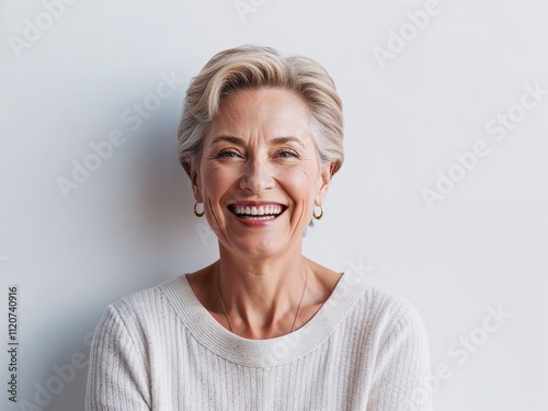 A studio portrait 60-year old woman, old woman smiling, professional photography with white background