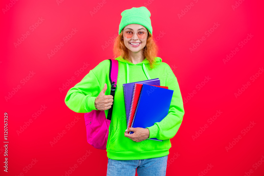 Knowledge and education. School education. Modern education. Girl student hold workbook. Back to school. Knowledge day. Education in college. Homework of girl isolated on pink. Thumb up Knowledge and education. School education. Modern education. Girl student hold workbook. Back to school. Knowledge day. Education in college. Homework of girl isolated on pink. Thumb up