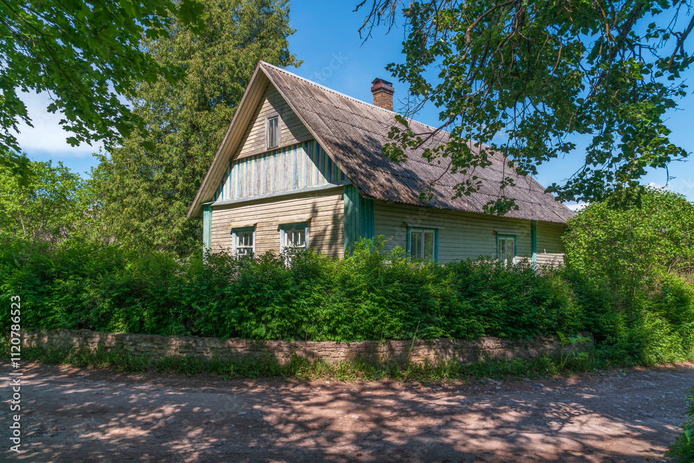 View of a traditional Russian wooden village house on a sunny summer day, Izborsk, Pskov region, Russia View of a traditional Russian wooden village house on a sunny summer day, Izborsk, Pskov region, Russia