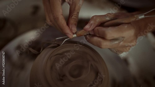 Close-Up Of Trimming Pottery Foot With Loop Tool