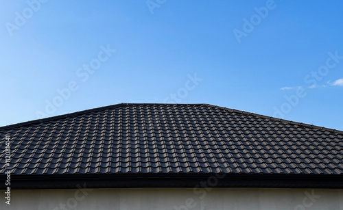 The structure of the roofs covered with metal tiles reflects modern construction trends with durable and stylish material photo