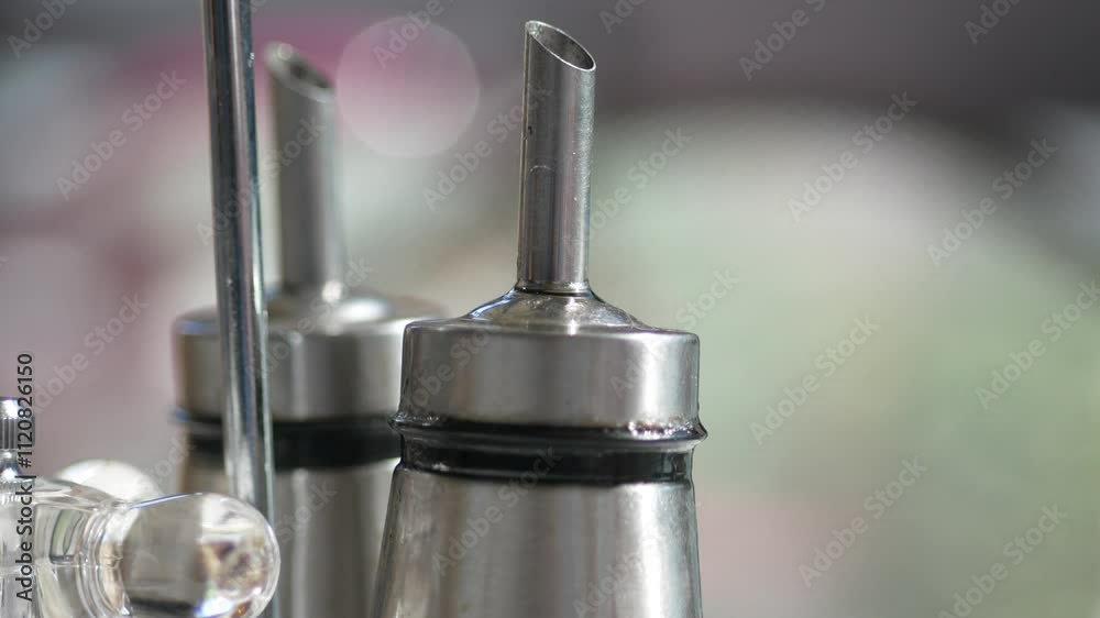 CloseUp of Olive Oil and Vinegar Dispensers in Natural Lighting, Perfect for Cooking and Seasoning CloseUp of Olive Oil and Vinegar Dispensers in Natural Lighting, Perfect for Cooking and Seasoning