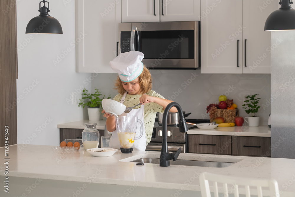 Child chef cook prepares food at kitchen. Kids cooking. Teen boy with apron and chef hat preparing a healthy meal. Child chef cook prepares food at kitchen. Kids cooking. Teen boy with apron and chef hat preparing a healthy meal.
