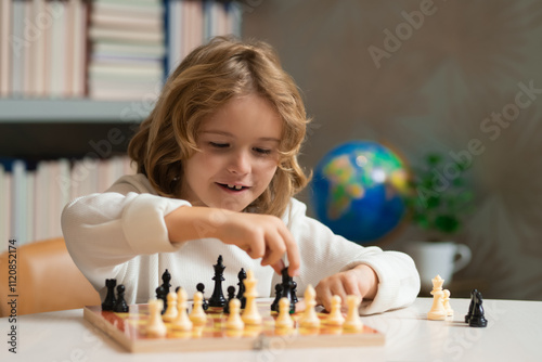 Smart kid playing chess. Clever child thinking about chess. photo